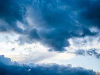 Cloudy sky full of deep grey clouds. Storm is coming. Dark blue stormy cloudy sky. Natural photo background.
