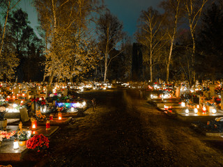 All Hallows' Day, Feast, Solemnity, Christian festival celebrated of all saints, Cemetery decorated with candles for All Saints Day at night on 1st November.