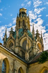 Fototapeta na wymiar Kladruby, Czech Republic / Europe - July 7 2018: Yellow dome of church of the Assumption of the Virgin Mary built in baroque gothic style, golden crown on top, sunny summer day, blue sky with clouds