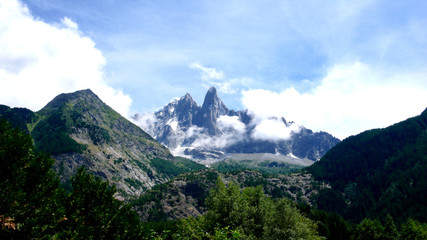 Fototapeta na wymiar jagged mountain peak landscape with clouds