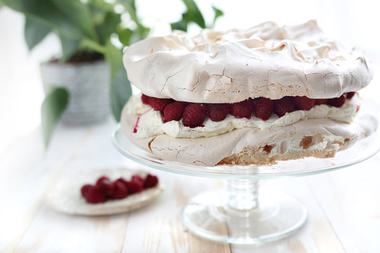 Beza z bita śmietana i malinami, słodki deser.