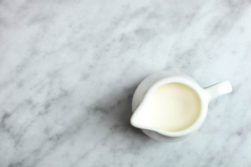 White milk jug with milk