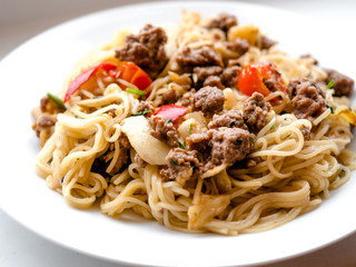 Chinese Thai style Stir fried yellow egg noodles with minced pork and vegetable, selective focus