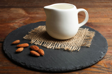 White milk jug and almonds nuts