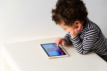 child playing with digital tablet