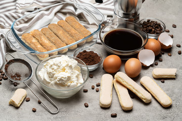 Ingredients for making traditional italian cake tiramisu on concrete table