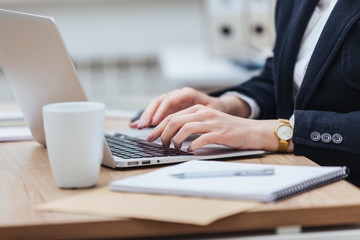 Close-up shot of woman's hands typing on a keyboard