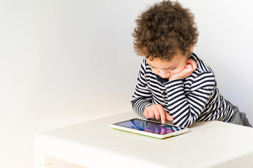 Fototapeta na wymiar child playing with digital tablet