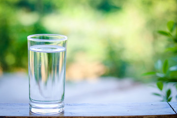 Clear glass, put clean drinking water on wooden floor.