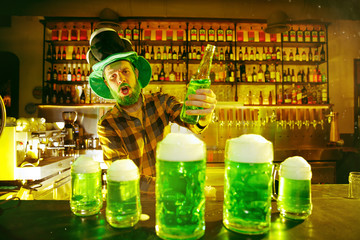 Saint Patrick's Day Party. Happy friends is celebrating and drinking green beer. Young men and women wearing a green hats. Pub Interior.