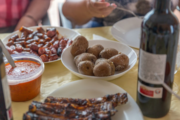 Potatoes, sausages and ribs ready to eat