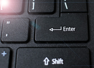 Enter button on laptop keyboard. Close up of Enter key of Laptop computer.  Enter keyboard key button on a computer with light effect. 