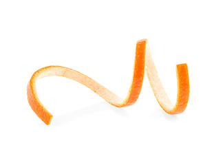 Twisted orange skin on a white background. Orange zest spiral.