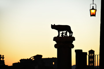 Silhouette of a she-wolf who nurtured the founders of Rome and the Roman roofs and bell towers...