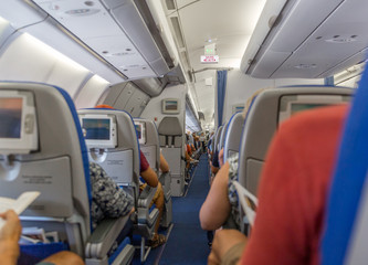 Interior of a commercial airplane with all passengers seated and ready for takeoff