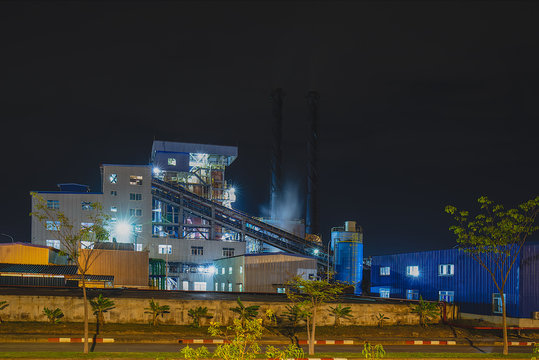 View of Coal-fired power generation plant industrial factories and waste heat recovery unit of turbine engine at night.