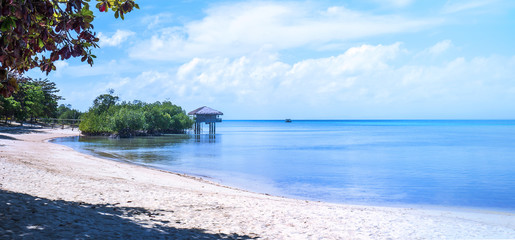 Chairs on the amazing beautiful sandy beach near the ocean with blue sky. Concept of summer leisure calm vacation for a tourism idea. Empty copy space, inspiration of tropical landscape