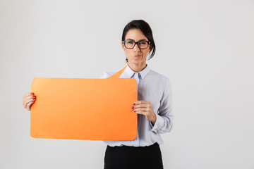 Image of happy office woman wearing eyeglasses holding yellow copyspace placard, isolated over white background