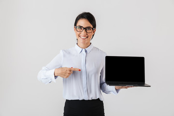 Portrait of happy businesswoman wearing eyeglasses holding silver laptop in the office, isolated over white background - obrazy, fototapety, plakaty