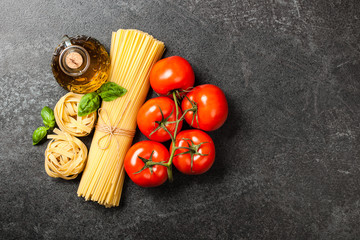 Pasta, tomatoes and olive oil on black