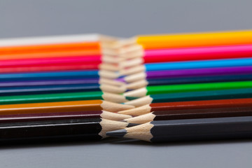Set of colored pastel pencils in row multi color in form of closed zipper