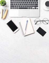 Stylized clean marble office working desk with smartphone, laptop, glasses and coffee, workspace design, mock up, top view, flat lay, copy space, closeup