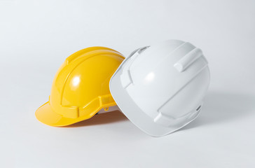 Plastic safety helmet for engineer on gray background.