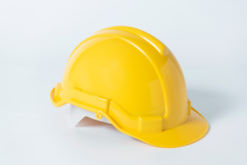 Plastic safety helmet for engineer on gray background.
