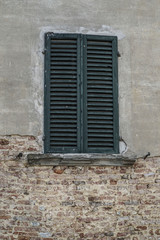 Fototapeta na wymiar closed green window blind of a building