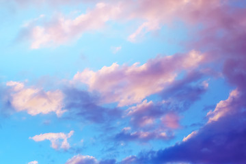 blurred image of a beautiful blue sky with clouds at early sunset.