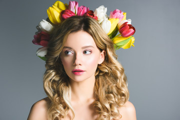 Naklejka premium beautiful girl with wreath of flowers on hair isolated on grey