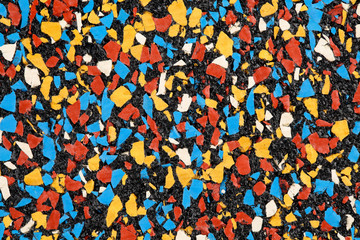 Multicolored rubber floor background texture. Shock absorbent flooring for gyms, playgrounds, sports and running tracks