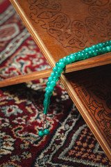 Muslim prayer beads on wooden background close up