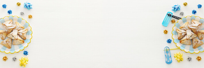 Purim celebration concept (jewish carnival holiday) over wooden white background.