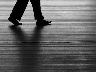 black and white silhouette walking on the floor