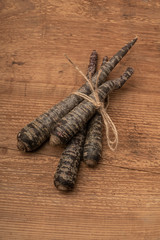 red carrots on wooden table with copy space