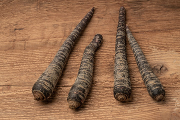 some red carrots on a wooden table