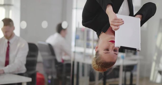 Successful business woman talking on the tablet by video chat.