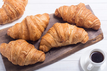Croissants on wooden background