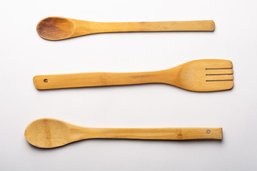Vintage Wooden Spoons and Fork on White Textured Paper. Kitchen and Cooking Concept.
