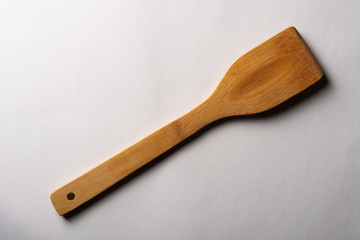 Vintage Wooden Stirrer on White Textured Paper. Kitchen and Cooking Concept.