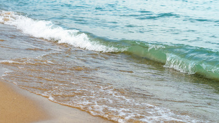Seaside beach and soft blue sea wave.