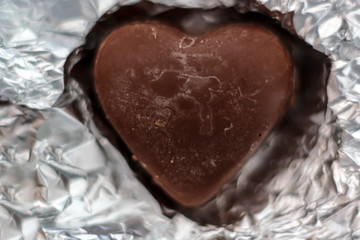 Chocolate heart on wrapping paper