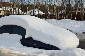 A parked car covered with snow