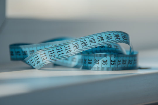 Blue measuring tape for the waist on the table. Diet. Fitness Slimming