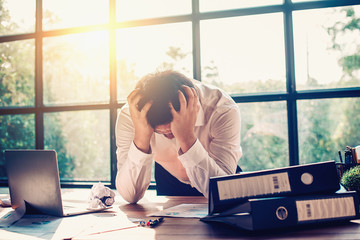 Businessmen are stressed with work in the office.