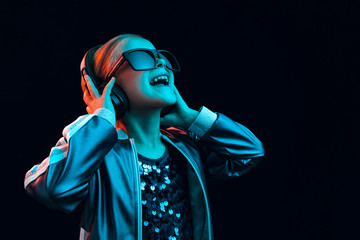 Neon portrait of young girl with headphones enjoying music. Lifestyle of young people, human...
