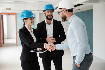 Engineers in hardhats have conversation