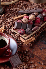 Various chocolates  and cup of black coffee.