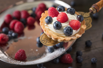  Dessert tarts with raspberries and blueberries.